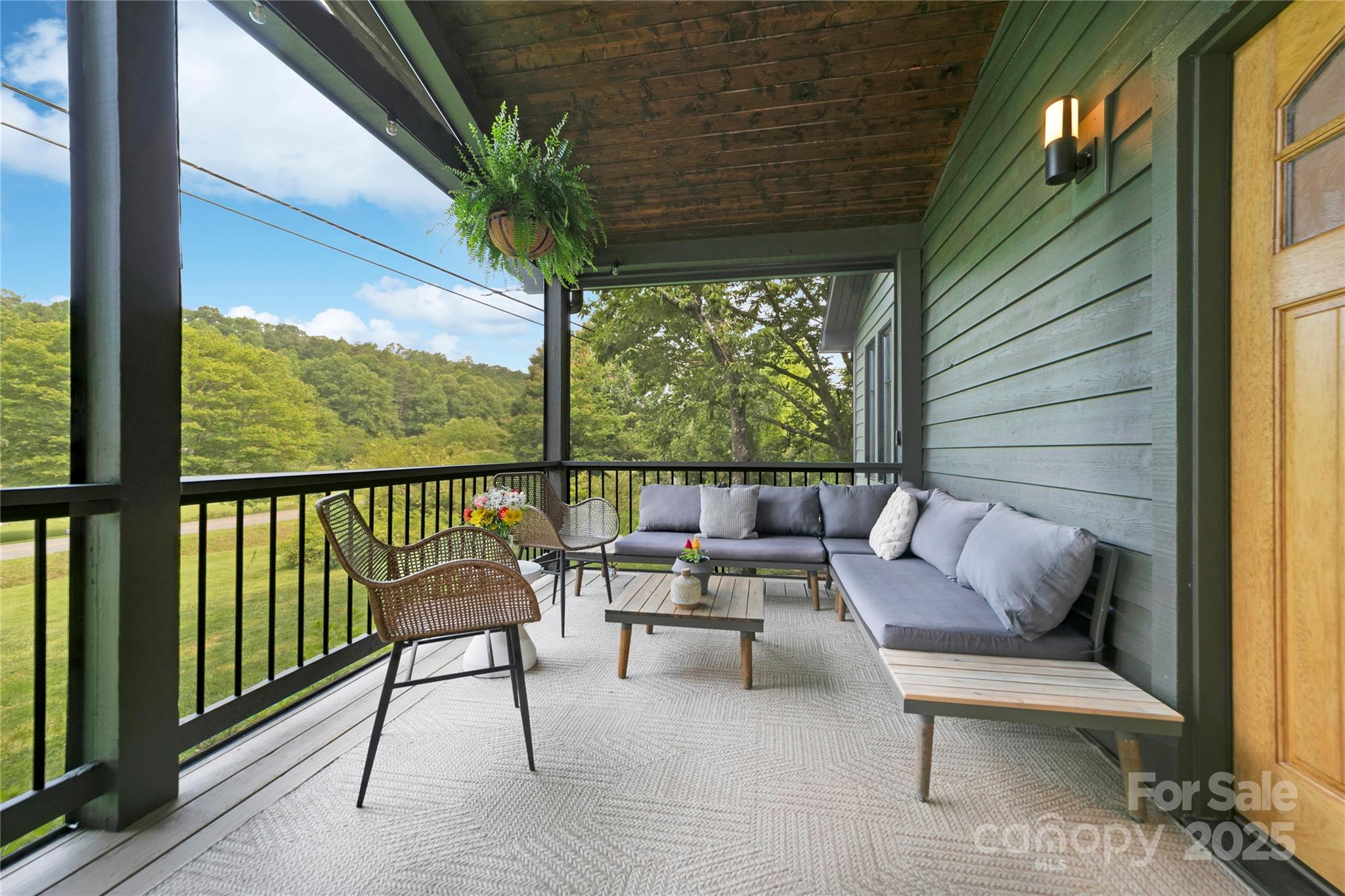 903 Middlefork Road Brevard, NC 28712 - Photo 3 of 45 a balcony with furniture and a potted plant