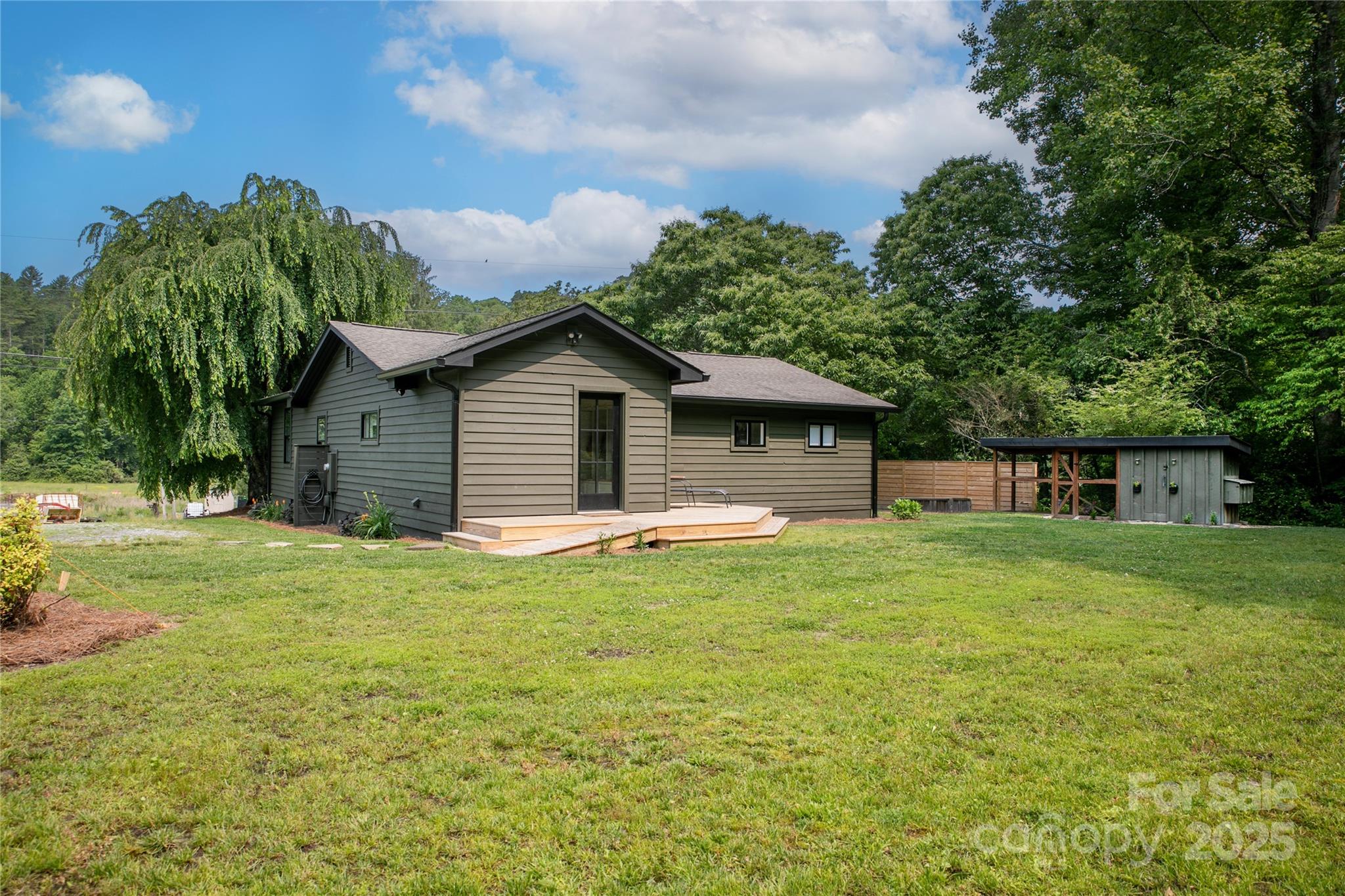 903 Middlefork Road Brevard, NC 28712 - Photo 42 of 45 a backyard of a house with table and chairs plants and large tree