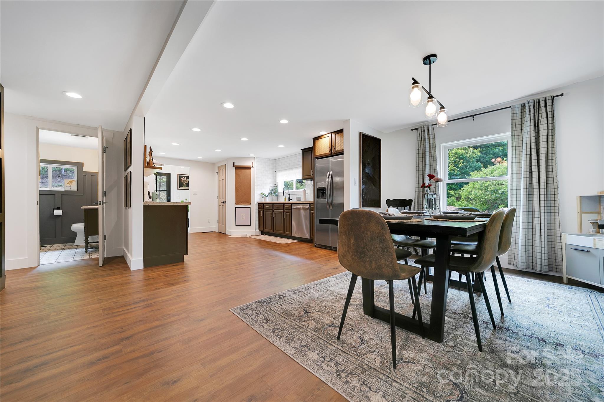 903 Middlefork Road Brevard, NC 28712 - Photo 10 of 45 a view of a dining room with furniture window and wooden floor
