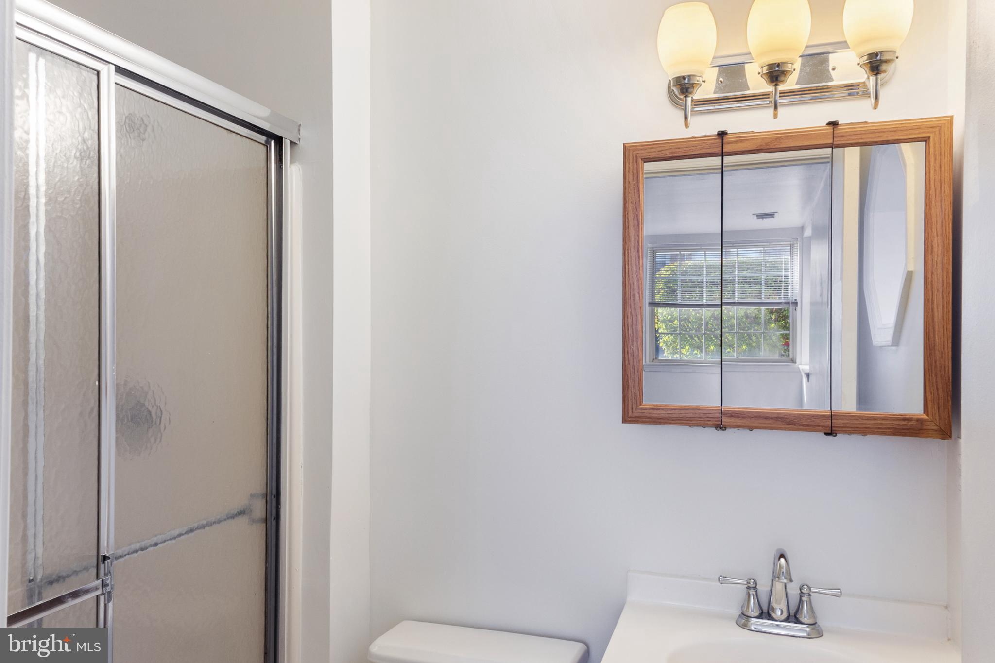 103 Three Coin Way, Unit 104 Glen Burnie, MD 21060 - Photo 16 of 19 a bathroom with a sink and a mirror