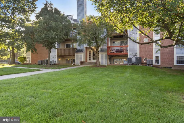 a view of a house with a yard and tree s