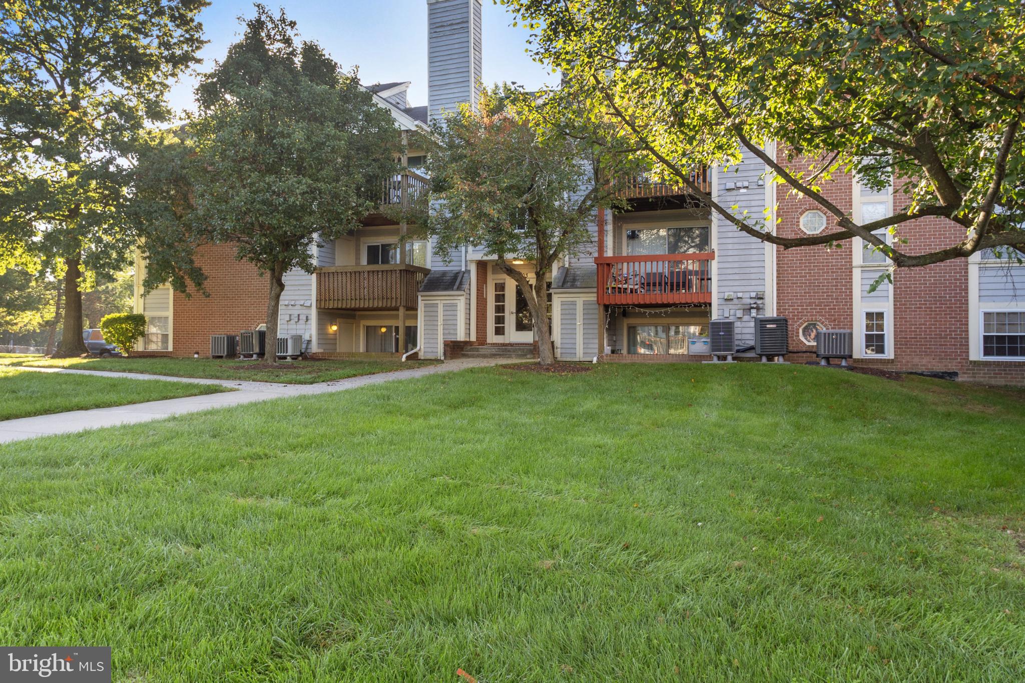 103 Three Coin Way, Unit 104 Glen Burnie, MD 21060 - Photo 17 of 19 a house view with a sitting space and garden
