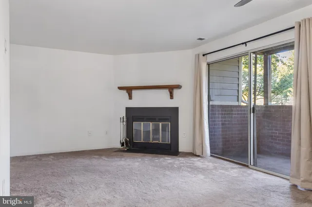 a view of an empty room with a fireplace