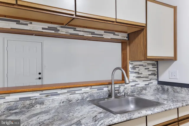 a kitchen with a sink and cabinets