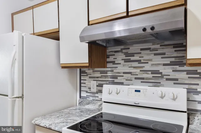 a bathroom with a bathtub shower sink vanity and a toilet