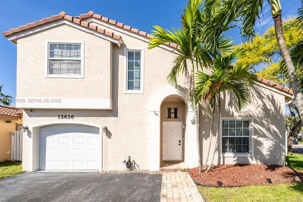 a front view of a house with a yard