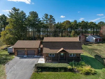 a aerial view of a house with a yard