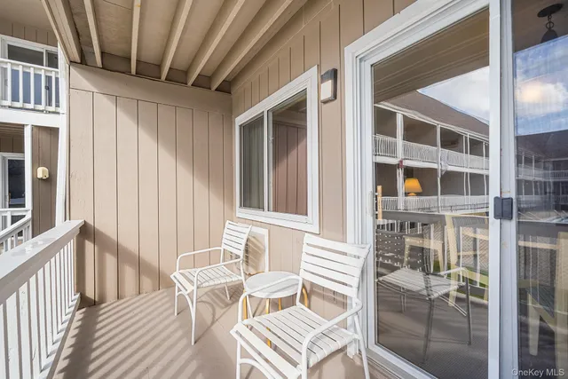a view of a balcony with chairs