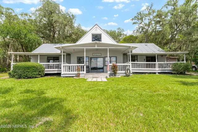 a view of a house with yard and tree s