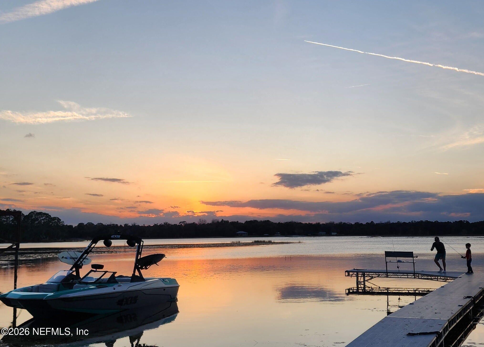 198 Lake Ray Road Hawthorne, FL 32640 - Photo 12 of 78 a view of a lake with a table and chairs under an umbrella