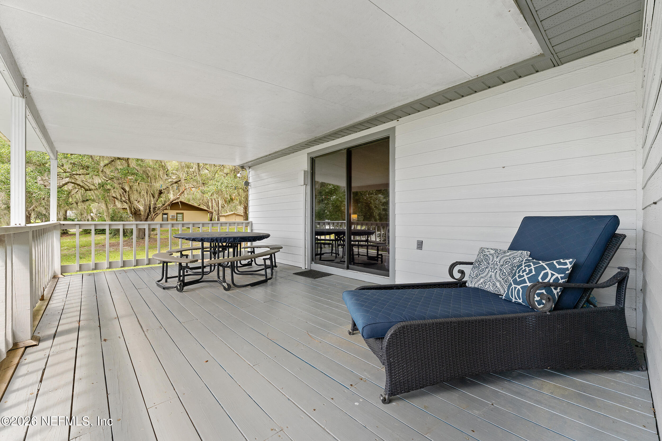 198 Lake Ray Road Hawthorne, FL 32640 - Photo 58 of 78 a living room with furniture and a large window with wooden floor