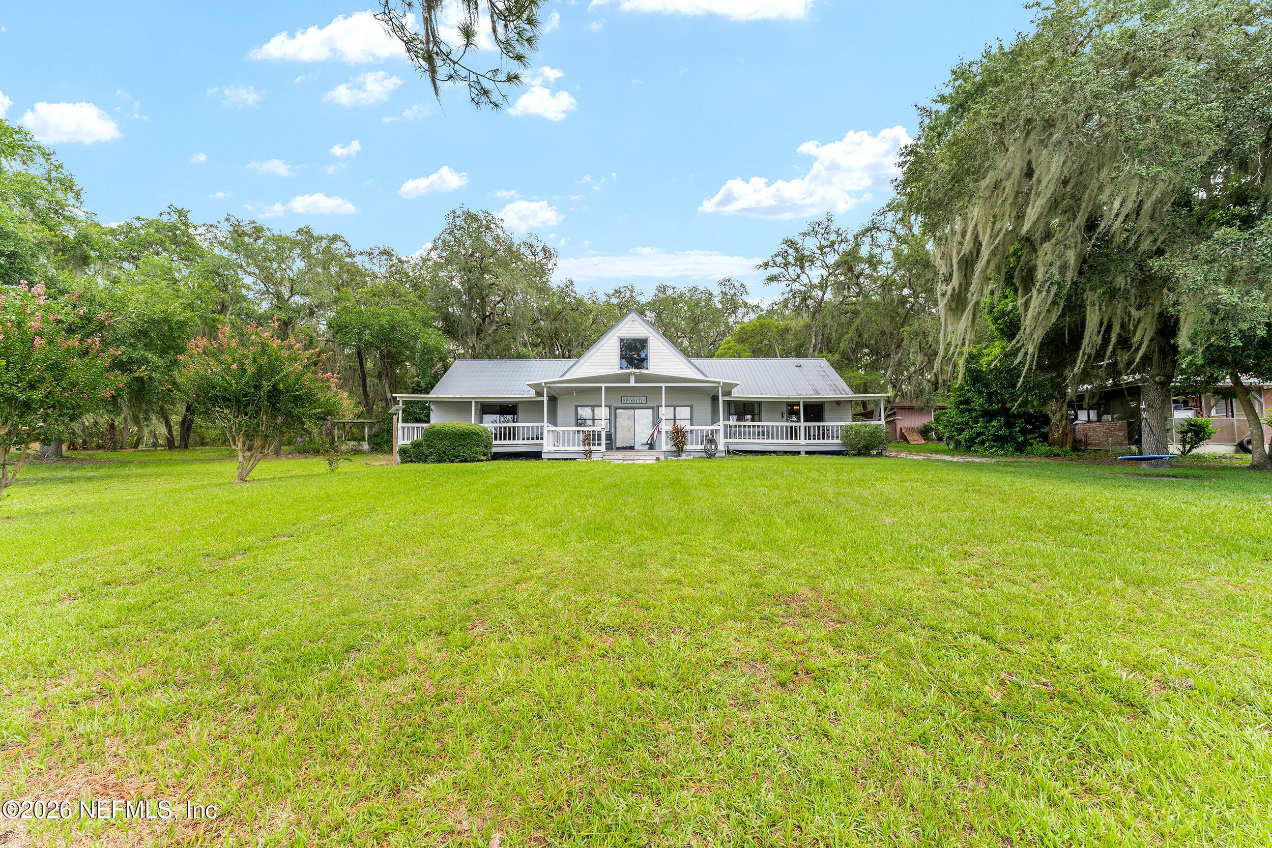 198 Lake Ray Road Hawthorne, FL 32640 - Photo 77 of 78 a front view of a house with garden and trees