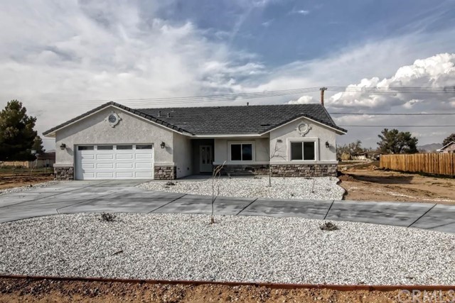 15577 Ute Road Apple Valley, CA 92307 - Photo 1 of 1 a view of a white house with a yard and large tree