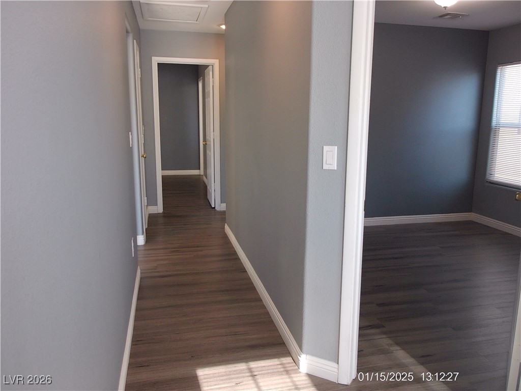 7332 Ribbon Ridge Avenue Las Vegas, NV 89129 - Photo 11 of 28 Hallway featuring dark wood-style floors