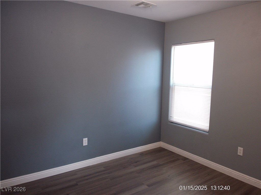7332 Ribbon Ridge Avenue Las Vegas, NV 89129 - Photo 13 of 28 Unfurnished room featuring baseboards and dark wood finished floors