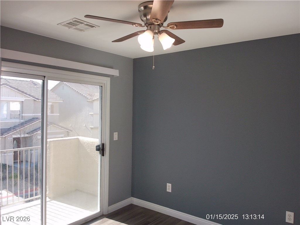 7332 Ribbon Ridge Avenue Las Vegas, NV 89129 - Photo 16 of 28 Empty room featuring a ceiling fan and dark wood-type flooring