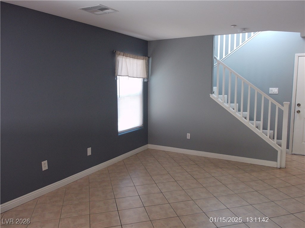 7332 Ribbon Ridge Avenue Las Vegas, NV 89129 - Photo 2 of 28 Unfurnished room with stairway and light tile patterned flooring