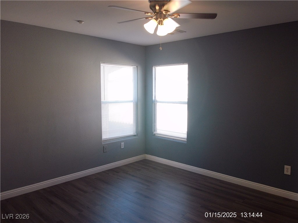 7332 Ribbon Ridge Avenue Las Vegas, NV 89129 - Photo 21 of 28 Empty room with dark wood-style flooring and ceiling fan