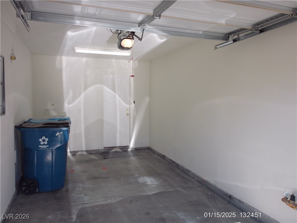 7332 Ribbon Ridge Avenue Las Vegas, NV 89129 - Photo 24 of 28 Garage with baseboards and a garage door opener
