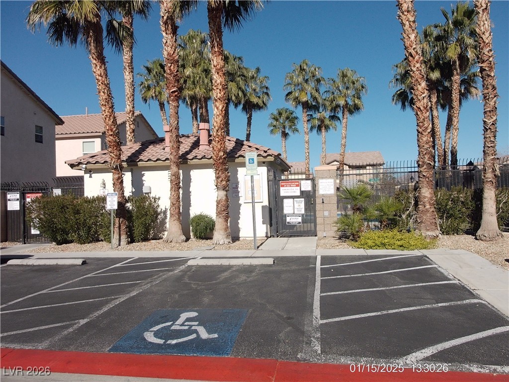 7332 Ribbon Ridge Avenue Las Vegas, NV 89129 - Photo 27 of 28 View of building exterior featuring uncovered parking