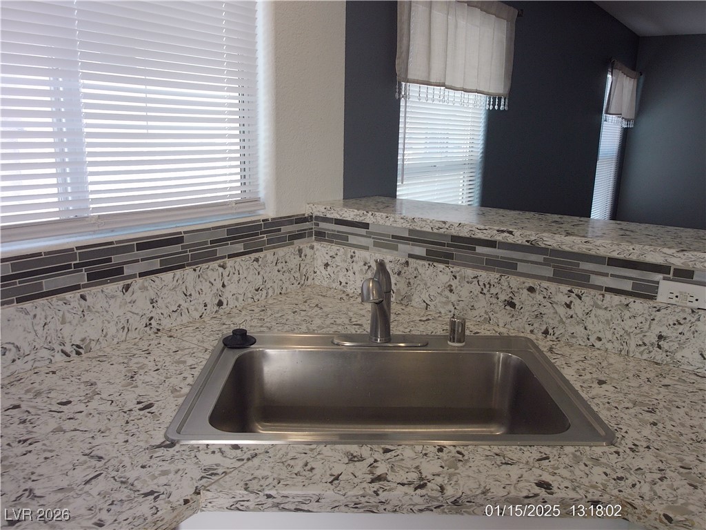 7332 Ribbon Ridge Avenue Las Vegas, NV 89129 - Photo 7 of 28 Kitchen view of light stone countertops and backsplash