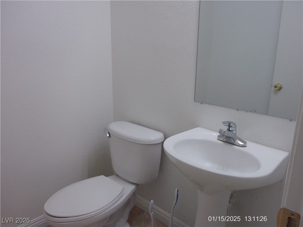 7332 Ribbon Ridge Avenue Las Vegas, NV 89129 - Photo 9 of 28 Half bath with a textured wall