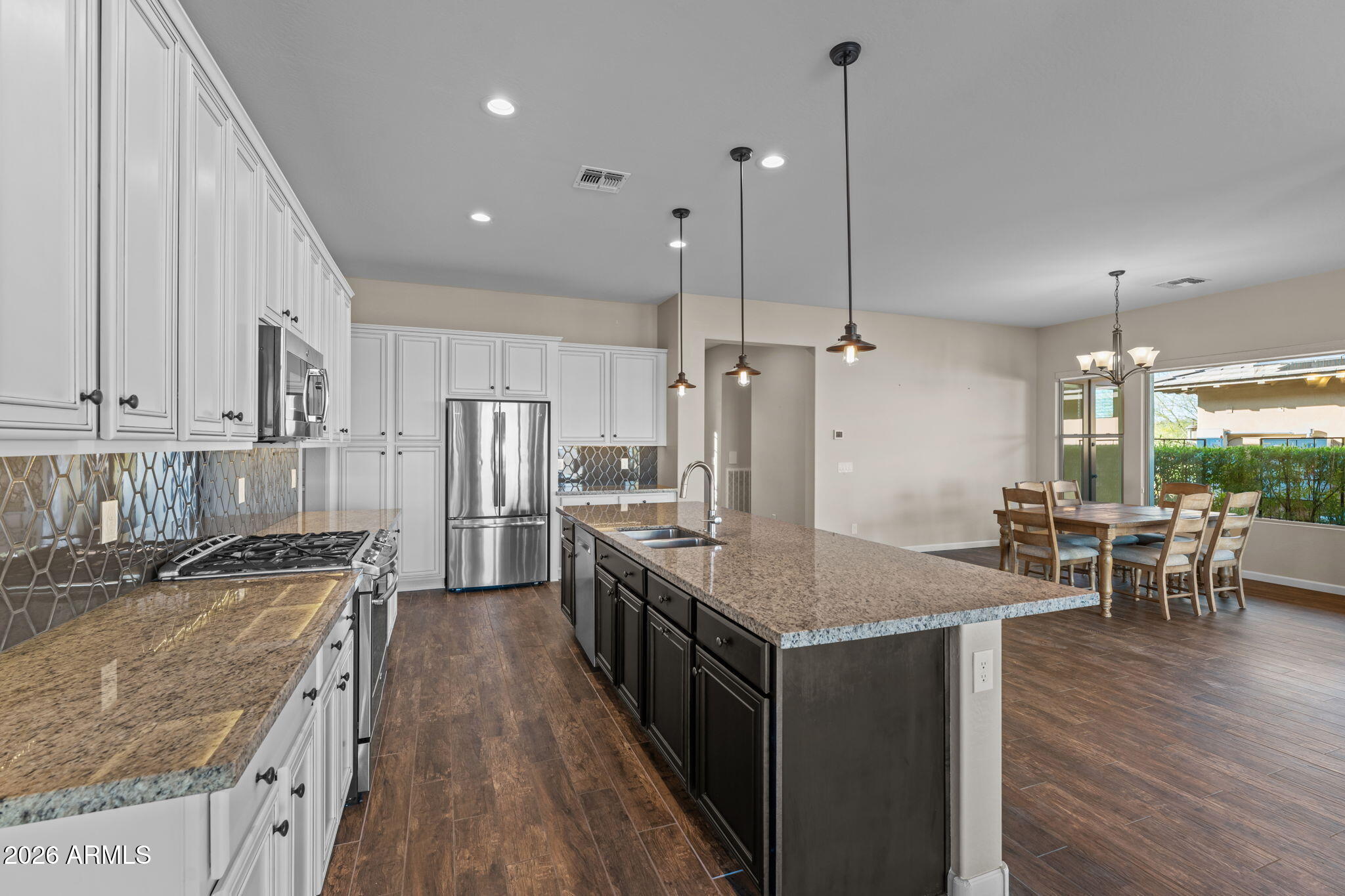 3675 Gold Ridge Road Wickenburg, AZ 85390 - Photo 11 of 58 a kitchen with stainless steel appliances granite countertop a sink refrigerator and cabinets