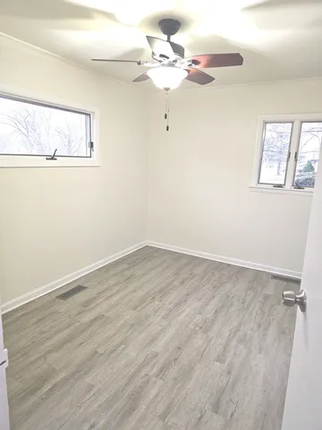 a view of a room with wooden floor