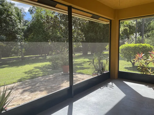 a view of a glass door with a yard