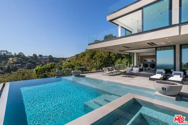 a view of a patio with swimming pool table and chairs