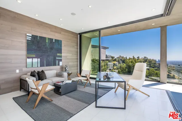 a building outdoor space with patio furniture and potted plants