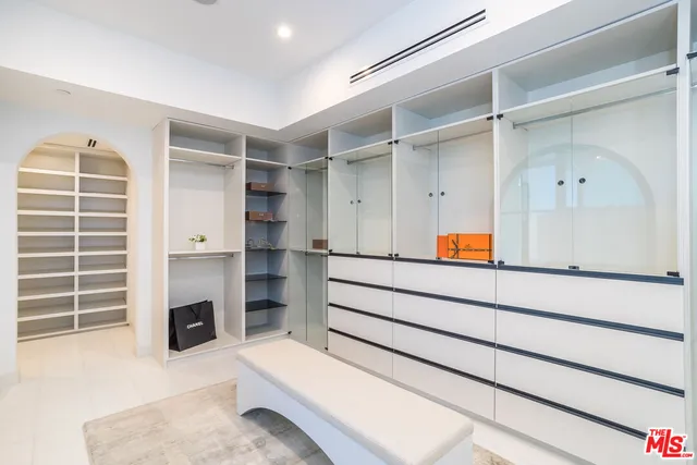 a view of an empty walk in closet and a window