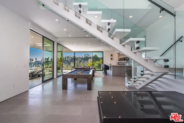 a view of a living room with a table and chairs