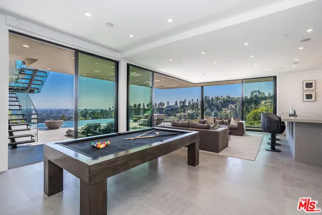 a kitchen with a sink a counter space and wooden floor