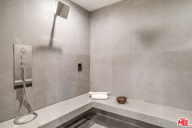 a view of an empty room with a fireplace and a large window