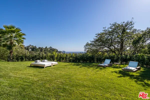 a view of a swimming pool and lounge chairs