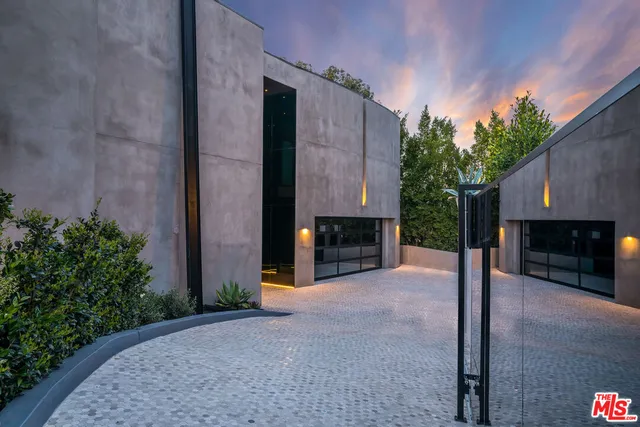 a view of an empty room with a fireplace and potted plants