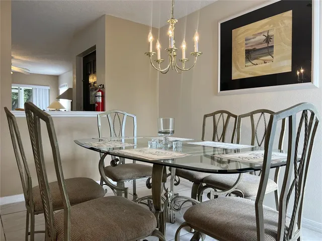 a view of a dining room with furniture and chandelier