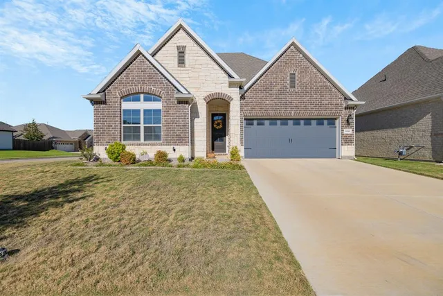 a front view of a house with a yard