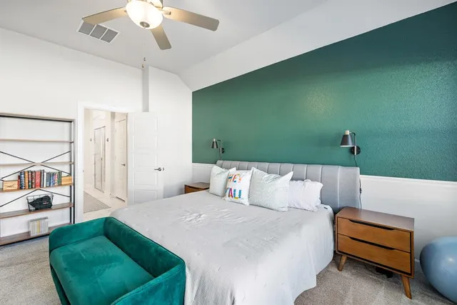 a bedroom with a bed furniture and a large window