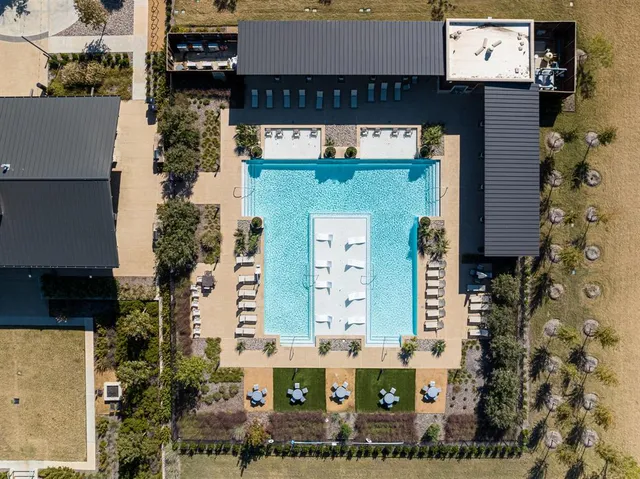 an aerial view of a residential building with an outdoor space