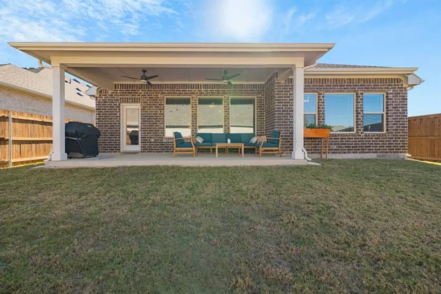 a view of a house with backyard porch and furniture