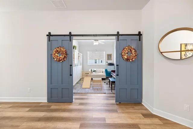 a view of living room with furniture and wooden floor