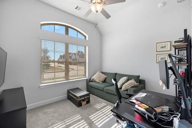 a living room with furniture a rug and a window