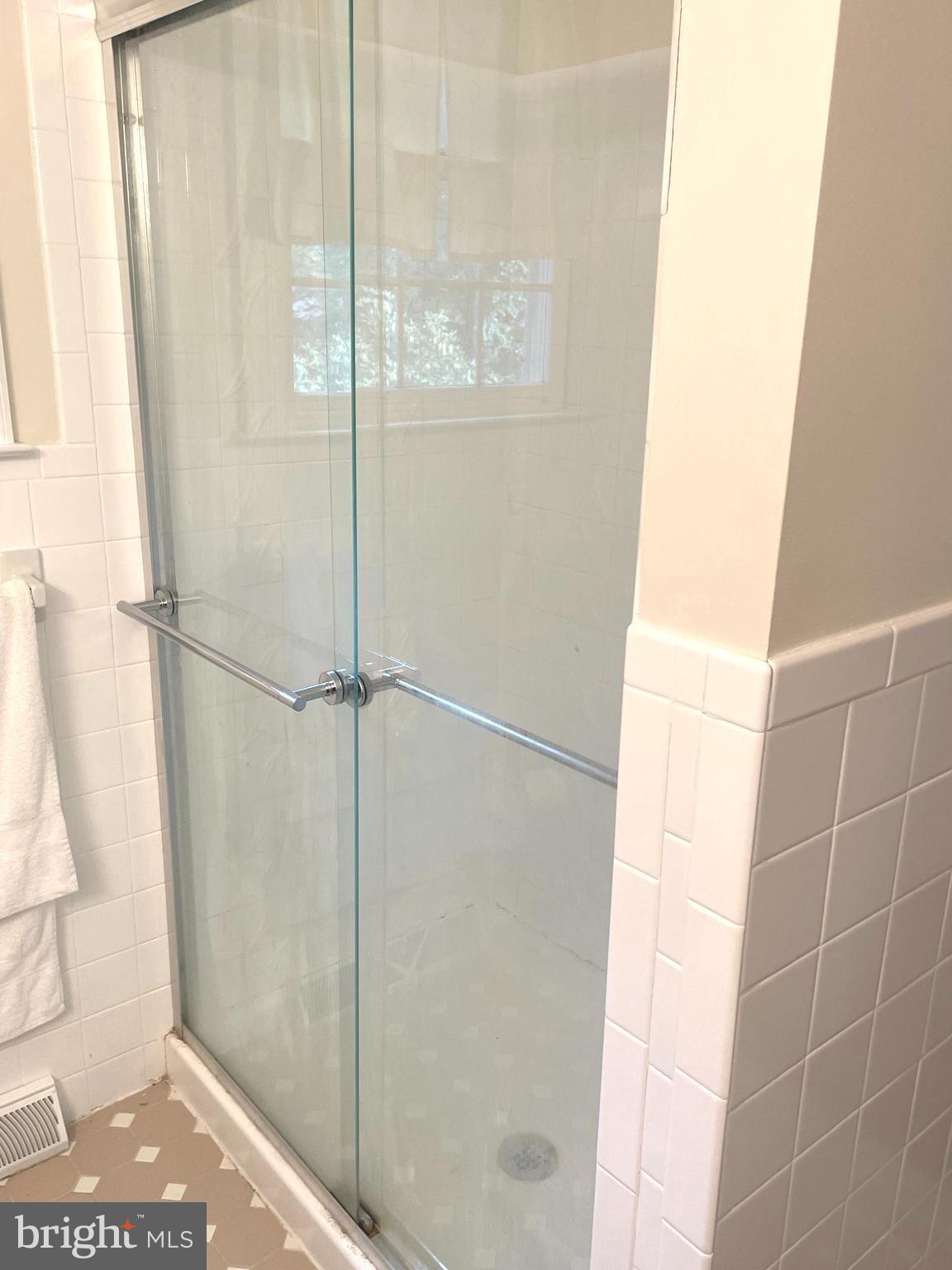 611 Andover Road Newtown Square, PA 19073 - Photo 23 of 27 a bathroom with a glass shower door