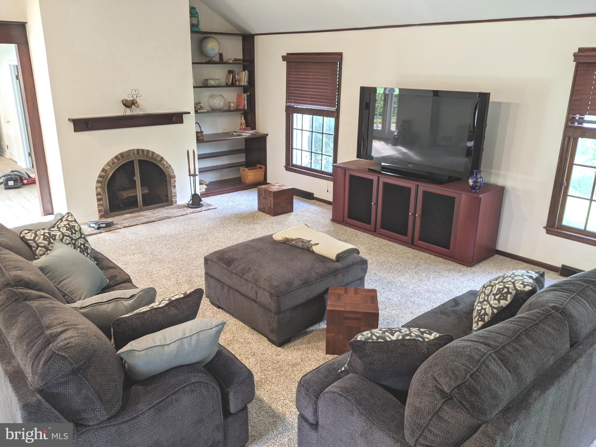 611 Andover Road Newtown Square, PA 19073 - Photo 5 of 27 a living room with furniture and a fireplace