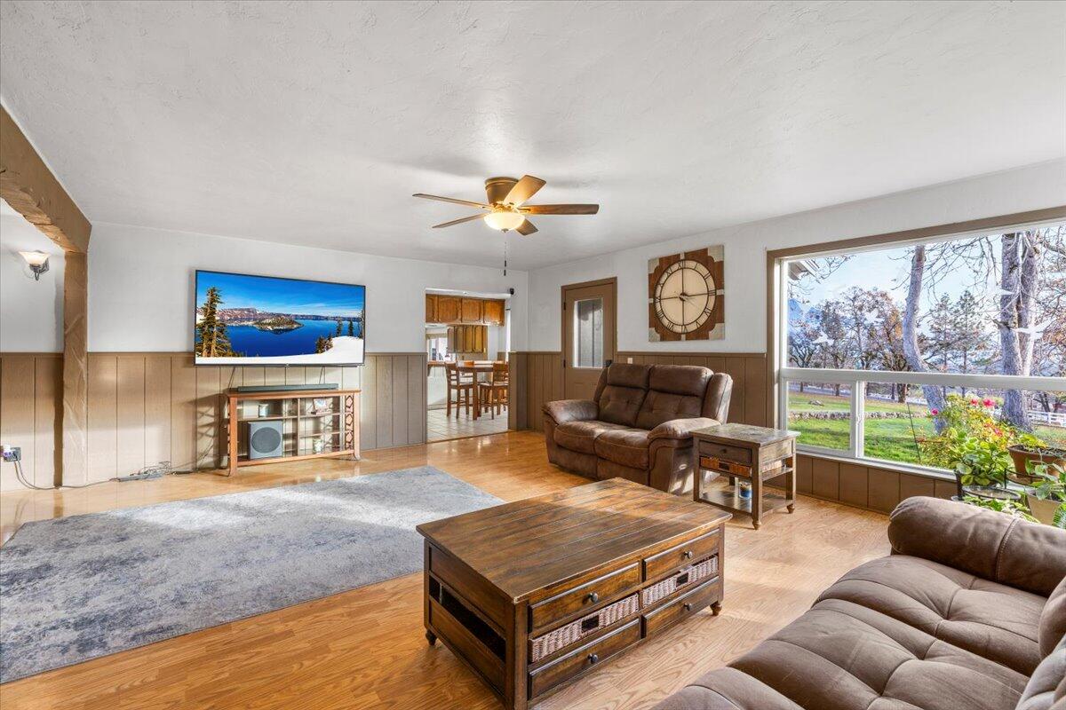 1360 Oxyoke Road Grants Pass, OR 97526 - Photo 17 of 39 a living room with furniture ceiling fan and a rug