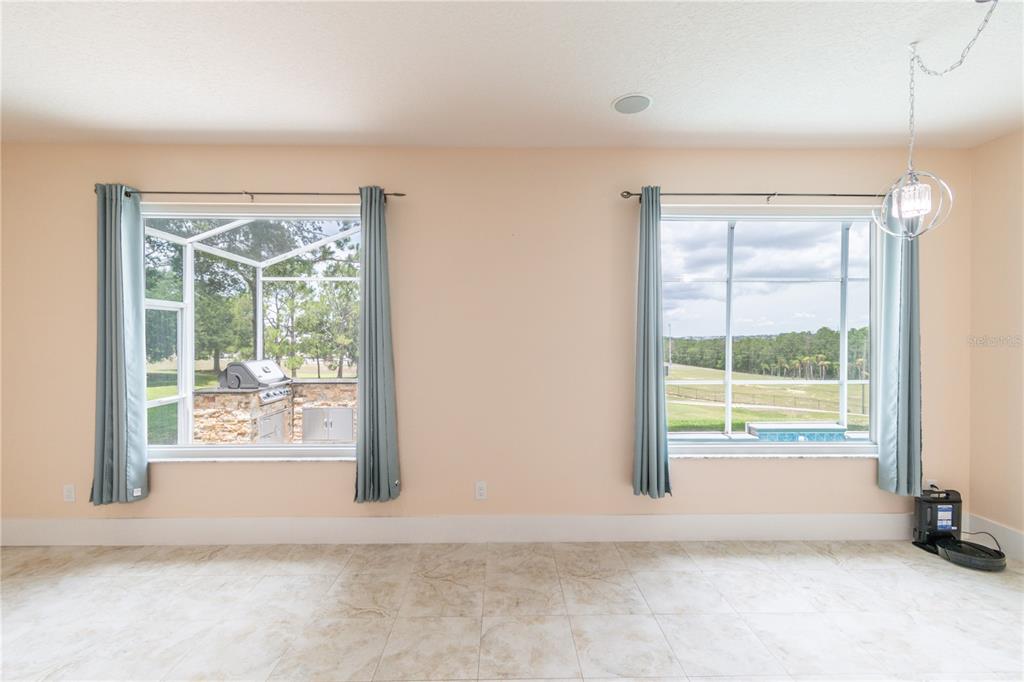 3862 Beacon Ridge Way Clermont, FL 34711 - Photo 23 of 56 an empty room with wooden floor and windows