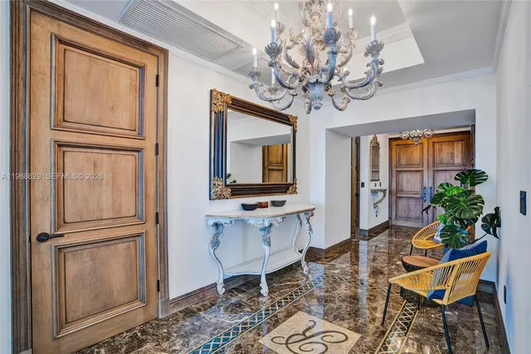 a view of a dining room with furniture a chandelier and wooden floor