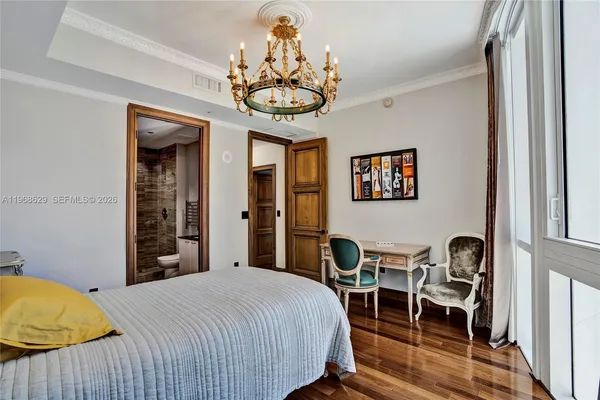 a bedroom with a bed and a chandelier